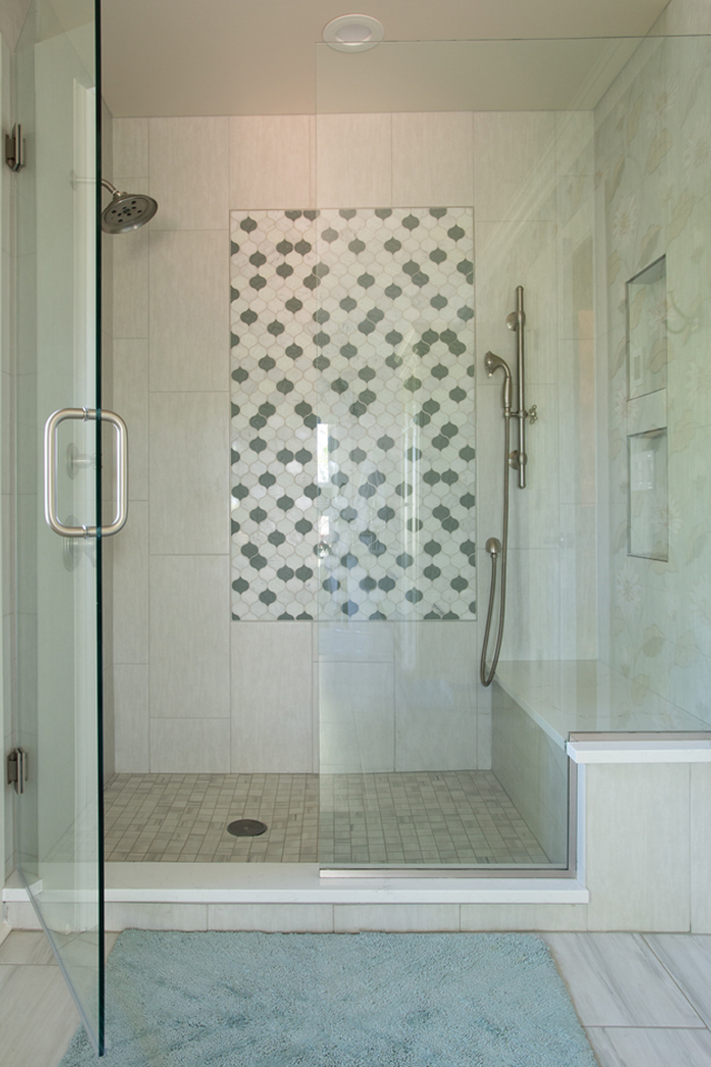Walk in shower with accent tile in center of shower wall